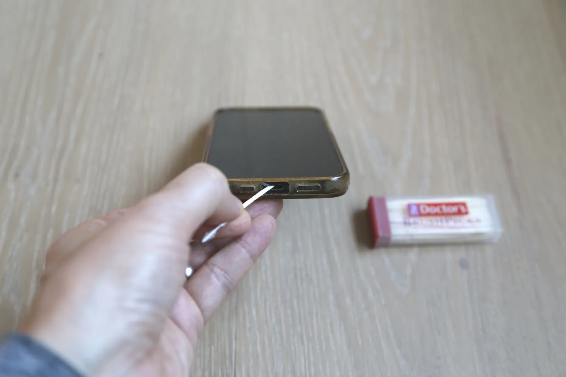 Cleaning an iPhone Lightning connector with The Doctor's BrushPicks